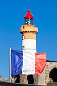 France, Finistere, Plougonvelin, Saint Mathieu point, The frech flag and the Saint Mathieu lighthouse listed as Historical Monument