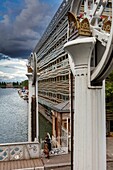 France, Paris, La Villette, Villette channel, view of the street animation of the quays of the canal of La Villette under a sky of storm