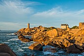 France, Cotes d'Armor, Ploumanach, Perros-Guirec, Pink granite coast, the lighthouse of Ploumanac'h or lighthouse of Mean Ruz at sunset on the footpath of Customs or GR Grande 34 hiking trail