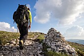 France, Drome, Vercors Regional Natural Park, hiker on the crest path of the plateau of Font d'Urle