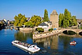 France, Bas Rhin, Strasbourg, old town listed as World Heritage by UNESCO, covered bridges dated 14th century on the Ill river, boat