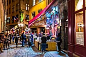 France, Rhone, Lyon, district of Cordeliers, Vieux-Lyon, street of la Monnaie, historical site listed as World Heritage by UNESCO, oysters and white wine as an aperitif in front of a Bouchon during the Fete des Lumieres (Light Festival)