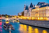 France, Paris, Seine river banks listed as World Heritage by UNESCO, the Conciergerie and a fly boat