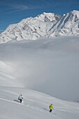 France, Haute Savoie, Massif of the Mont Blanc, the Contamines Montjoie, the ski on the tracks of the needle Croche over the cloud sea and the summits of the massif of the Mont Blanc