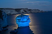 France, Corse du Sud, Bonifacio, a rock called sand grain forms a curious island a few meters from the shore under the lighting of the full moon