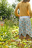 Woman walking in summer garden