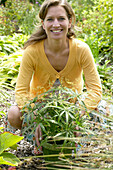 Woman with pot of ornamental grasses