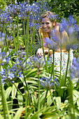 Woman behind agapanthus flowers