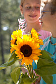 Two teenagers with sunflowers
