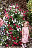 Girl in front of large petunia container