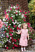 Girl in front of large petunia container