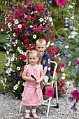 Children in front of large petunia container