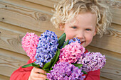 Girl holding hyacinths