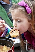 Girl tasting apple sauce