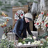 Woman making christmas arrangement