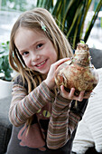 Girl holding amaryllis bulb