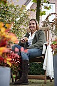 Woman sitting in autumn garden