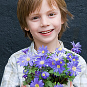 Boy holding anemone blanda