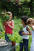Children with vegetable plants