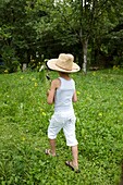 Boy walking with aubergine plant