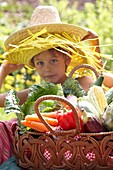 Boy holding basket with vegetables