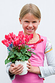 Girl holding Cyclamen