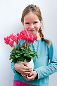 Girl holding Cyclamen