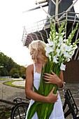 Woman holding gladiolus