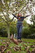 Woman throwing  leaves