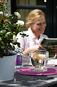 Woman reading at garden table