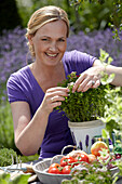 Frau bei der Gartenarbeit mit Kräutern