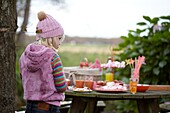 Girl making marshmallow skewers