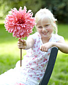 Girl holding dahlia