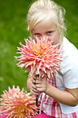 Girl holding dahlia