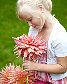 Girl holding dahlia