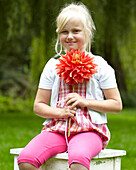 Girl holding dahlia