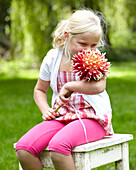 Girl holding dahlia