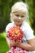 Girl holding dahlia