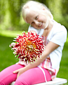 Girl holding dahlia