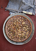 Castagnaccio with sultanas, pine nuts and rosemary