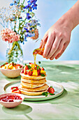 Pancakes with fresh fruit and honey