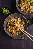 Asian pan with noodles, Brussels sprouts, cashews and spring onions