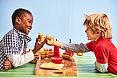 Two boys eating hot dogs