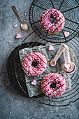 Pink donuts with colourful sprinkles