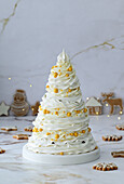 Four-tier Pavlova cake with berry filling and mascarpone cream in the shape of a Christmas tree