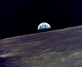 Earth rising above the lunar horizon