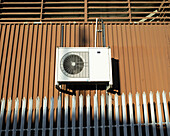 Air conditioning condenser unit on side of factory