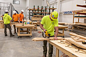 Apprentices learning carpentry skills