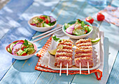 Grilled tataki salmon skewers with cucumber salad