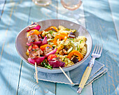 Filet mignon tomato skewers and pasta salad with vegetables